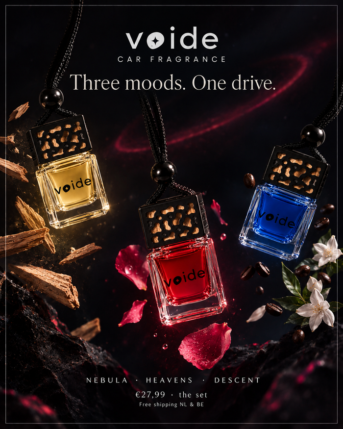 Three Voide car fragrance oil bottles with decorative black caps and black cords, shown in amber, red, and blue liquids against a dark moody background with wood chips, petals, and flowers. Text at the top reads 'voide CAR FRAGRANCE' and 'Three moods.