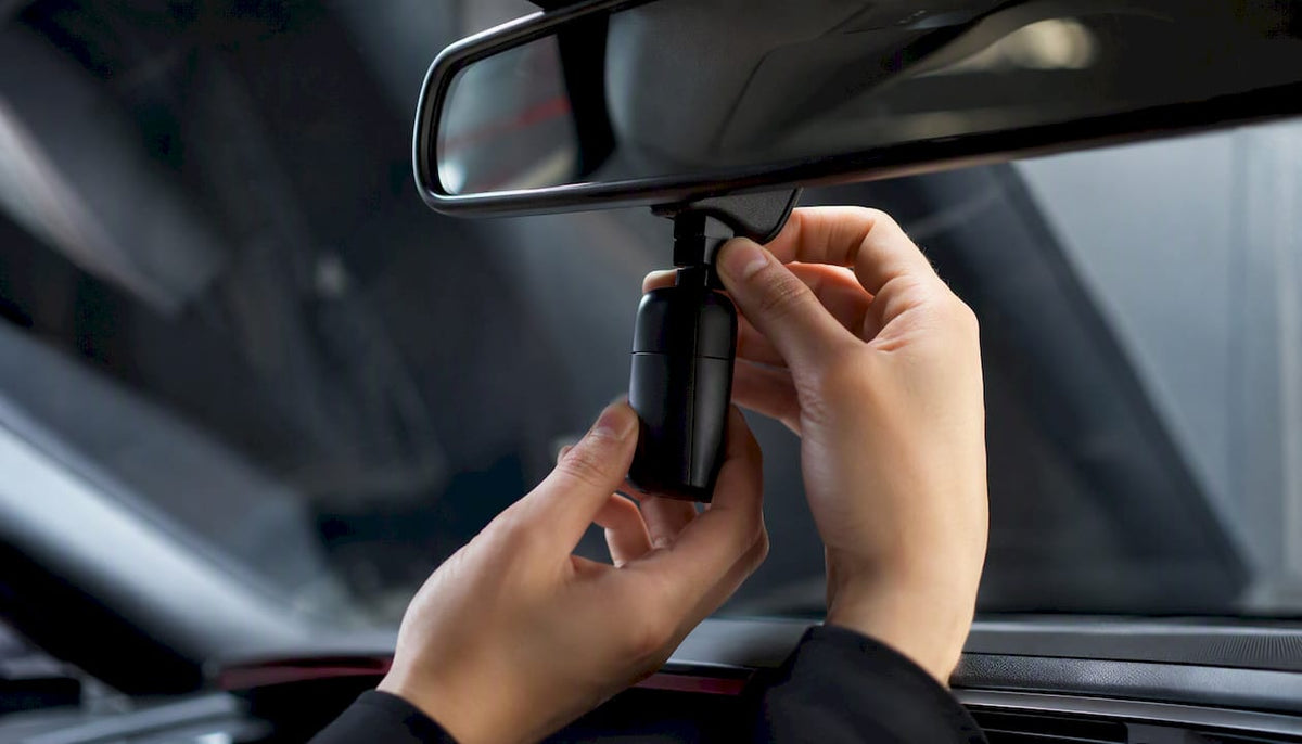 Hand attaching minimalist car scent diffuser