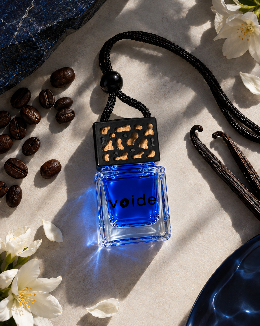 Descent car fragrance bottle with coffee beans, vanilla pods and white flowers