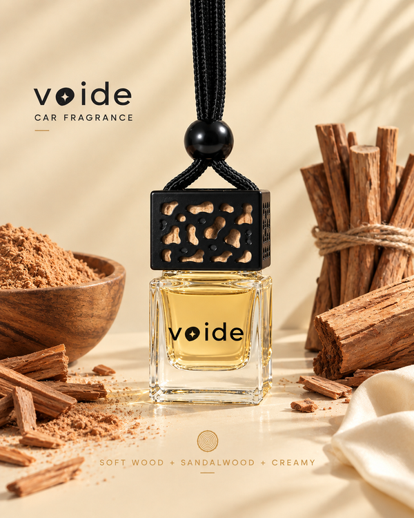 Heavens car fragrance: yellow sandalwood oil in a glass bottle with a black cap, next to sandalwood sticks